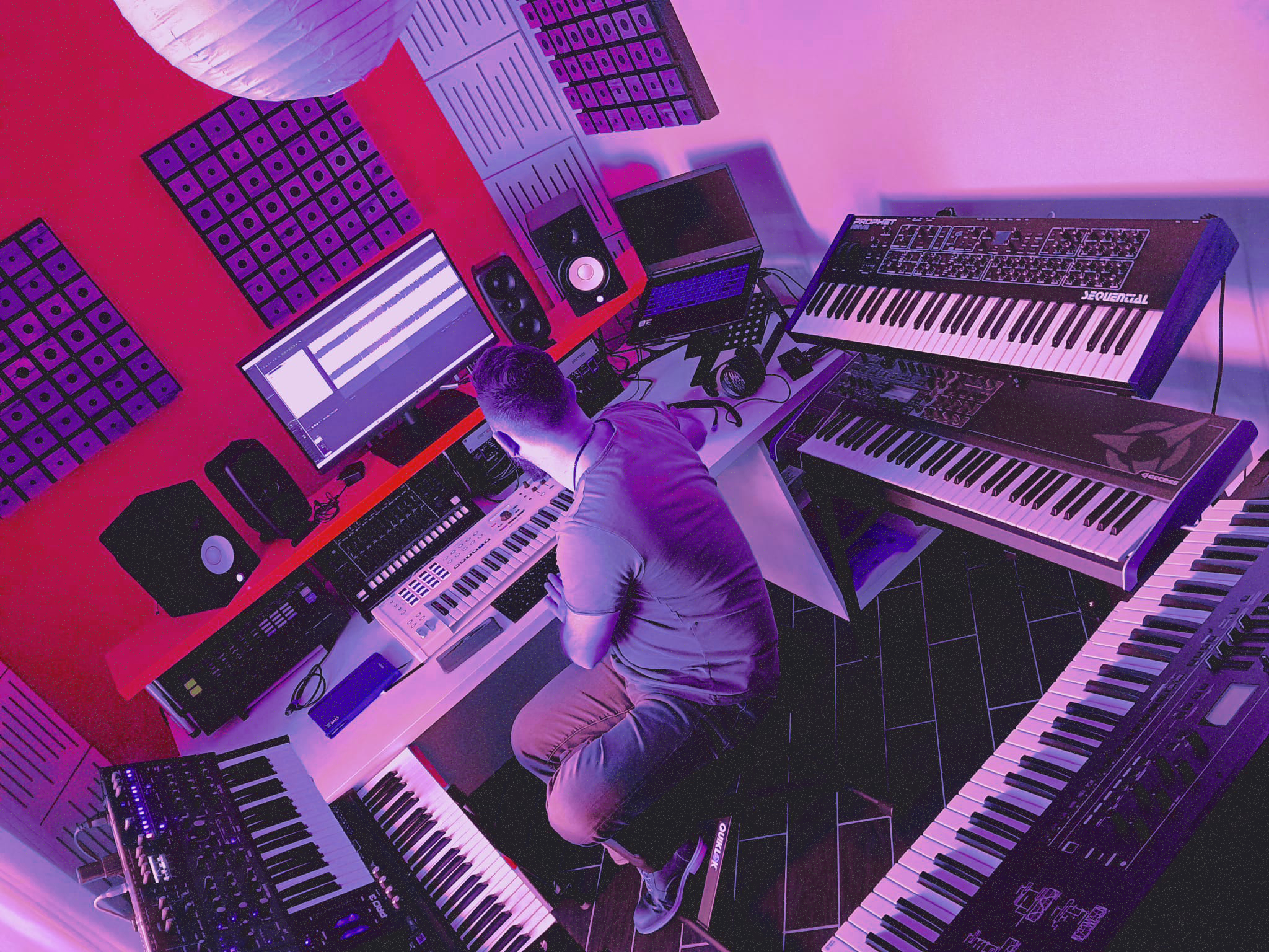 DipA in his home studio surrounded by synthesizers and music production gear